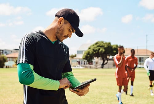 athletic trainer documenting injuries on tablet